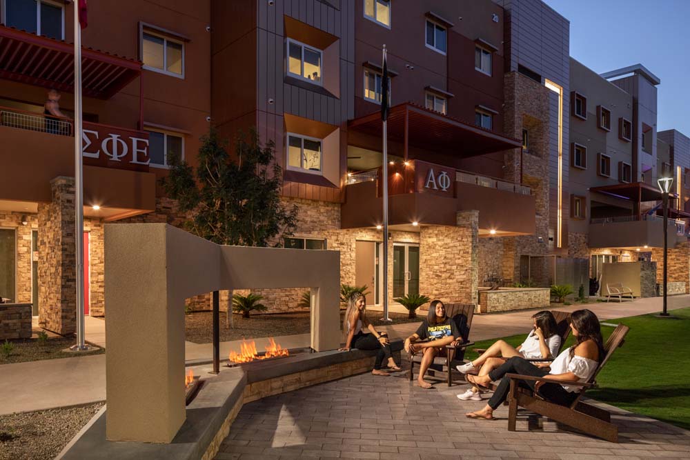Students gathering by fireplace at the student housing