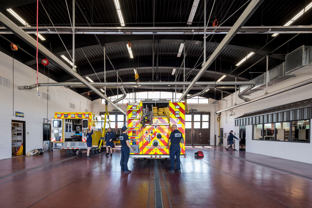 Fire station bays with firefighters