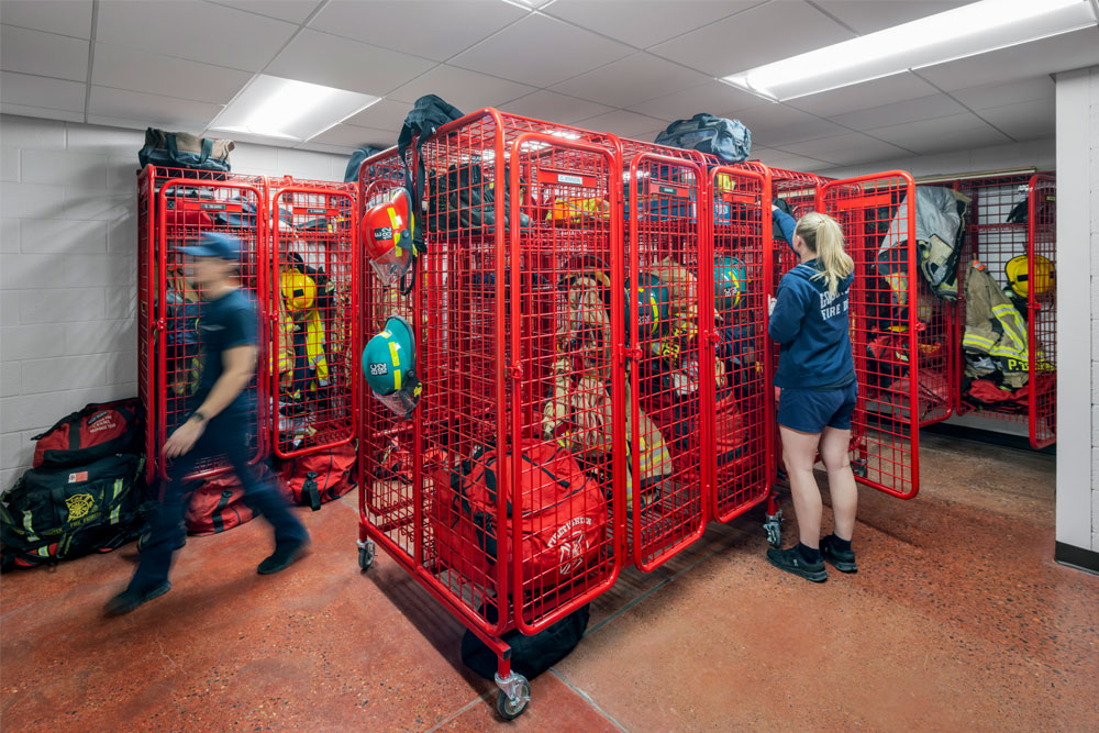 Firefighters in the fire station's turnout room