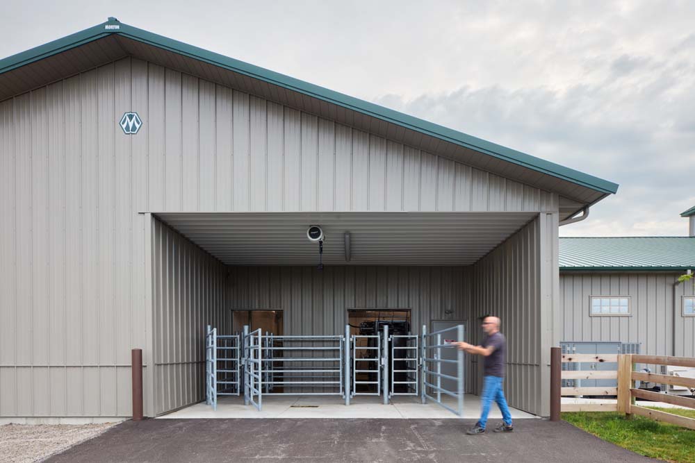 View of man opening the gate of the large animal facility